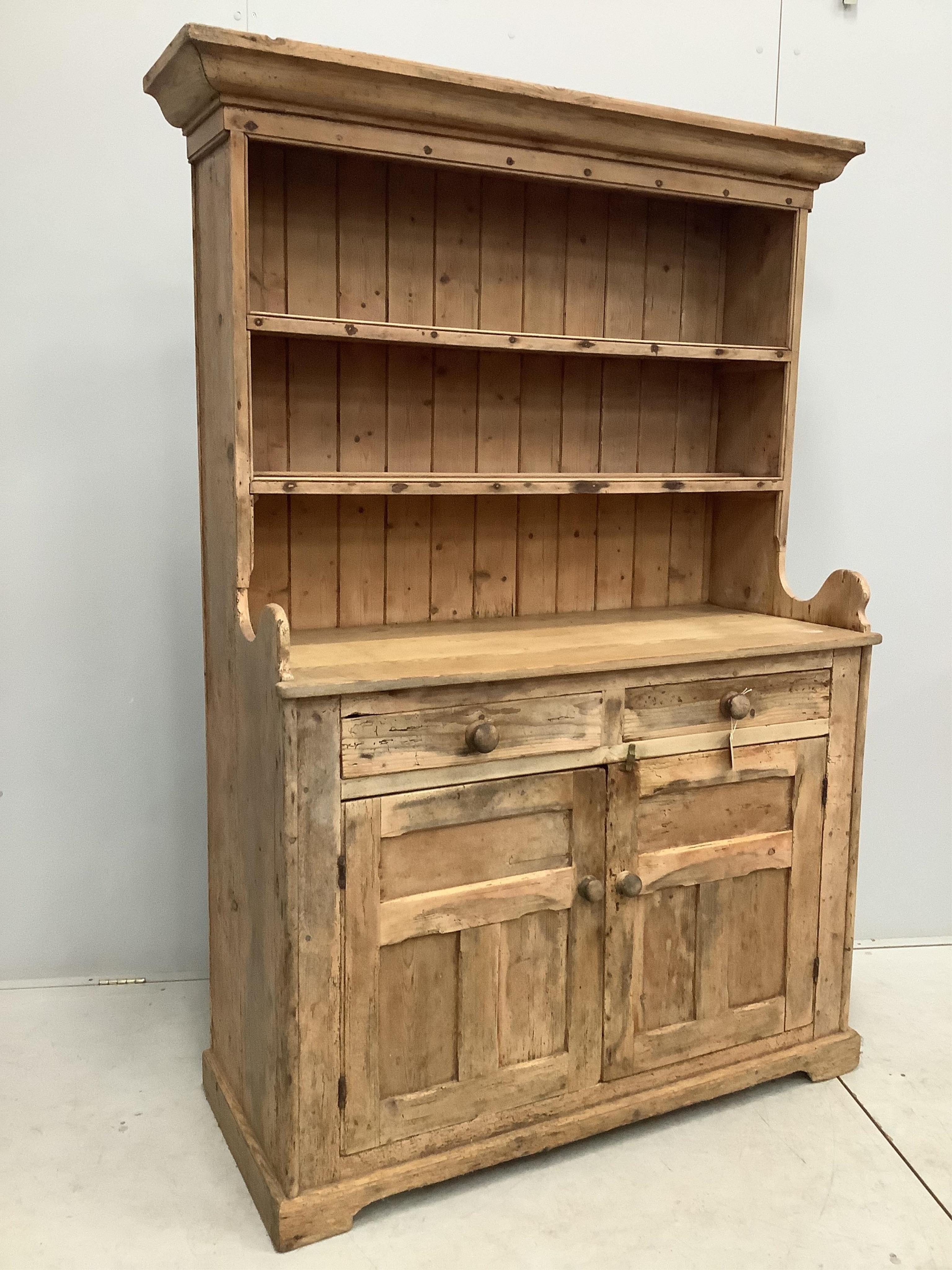 A 19th century Irish pine dresser with boarded rack, width 124cm, 51cm, height 122cm. Condition - fair